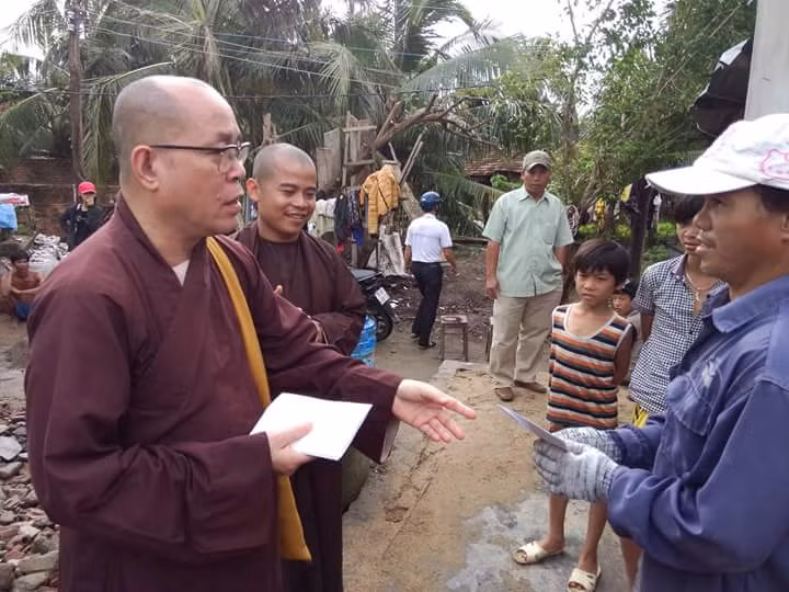 Thượng tọa Thích Đạt Đức trao tiền hỗ trợ cho các gia đình tại huyện Vạn Ninh