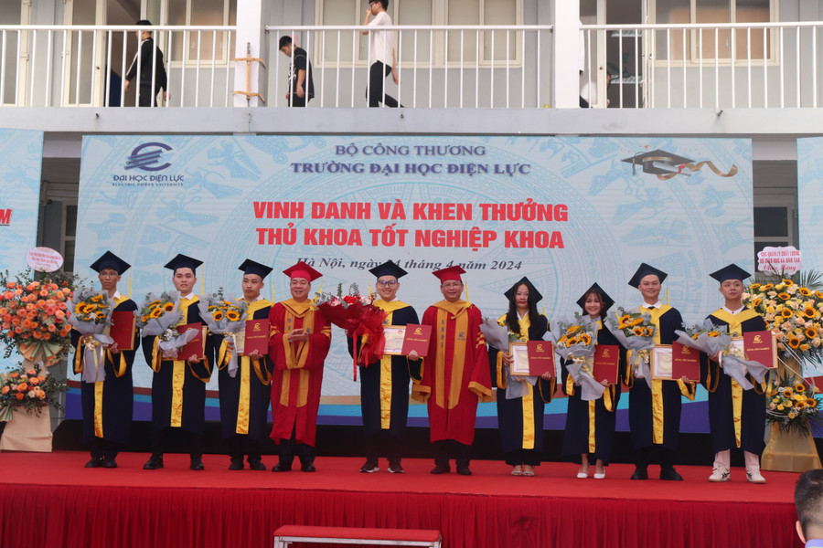 PGS.TS Vũ Đình Ngọ - Chủ tịch Hội đồng trường (bên trái) và PGS.TS Đinh Văn Châu - Hiệu trưởng trường Đại học Điện lực trao bằng tốt nghiệp và vinh danh thủ khoa tốt nghiệp khoa.