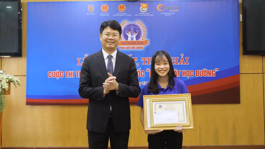 Thứ trưởng Bộ Tư pháp Nguyễn Thanh Tịnh trao bằng khen cho thí sinh đạt giải Nhất (Nguyễn Thị Huyền Trang – sinh viên trường Cao đẳng Y tế Huế)