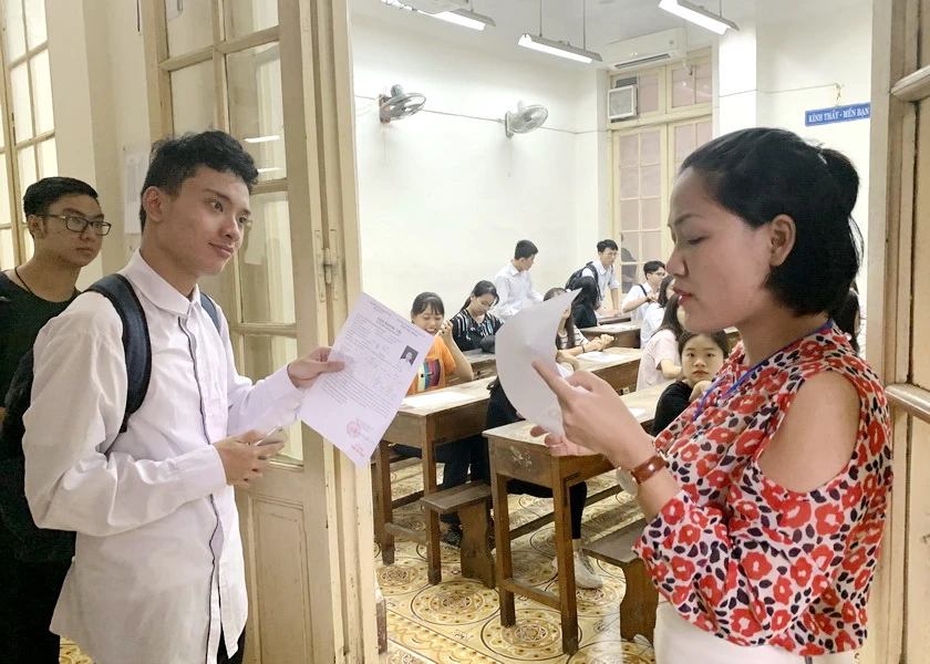 Cán bộ coi thi gọi thí sinh vào phòng thi.