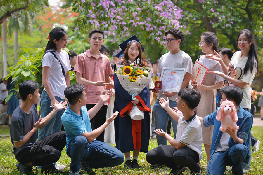 Bùi Thị Thuỳ (thứ ba từ trái sang, hàng 2) được các bạn đến chúc mừng trong lễ tốt nghiệp.