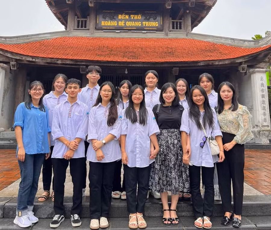 Quỳnh Như (hàng thứ 2, đứng thứ 3 từ trái sang) cùng cô giáo đến thắp hương tại đền thờ Hoàng đế Quang Trung trước ngày đi thi. Ảnh NTCC.