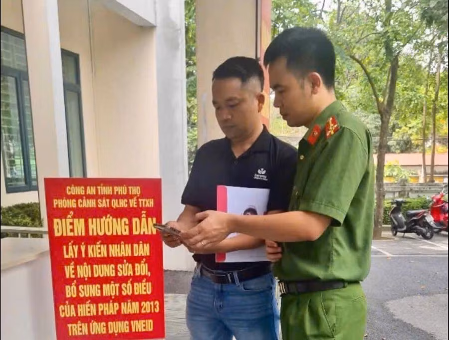 Cán bộ Phòng Cảnh sát QLHC về TTXH Công an tỉnh Phú Thọ hướng dẫn người dân đóng góp ý kiến vào dự thảo sửa đổi, bổ sung Hiến pháp năm 2013 qua ứng dụng VneID (Ảnh: CA tỉnh Phú Thọ).