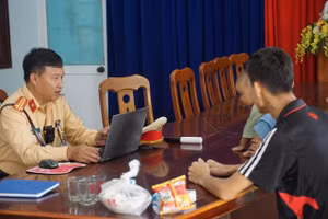 Trung tá Lê Phước Ngãi trao đổi với anh Đỗ Bá Duy. Ảnh: Công an