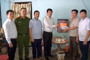 Ông Lê Văn Thạch, Bí thư Huyện ủy Tân Lạc (người thứ 4 từ trái sang) đến thăm và tặng quà người dân.