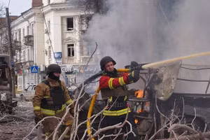 Lính cứu hỏa dập tắt đám cháy sau cuộc tấn công bằng tên lửa của Nga vào Sumy, Ukraine, ngày 13/4/2025.