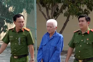 Lực lượng công an áp giải Trương Hồng Sang về nơi giam giữ. (Ảnh: Tiến Tầm)