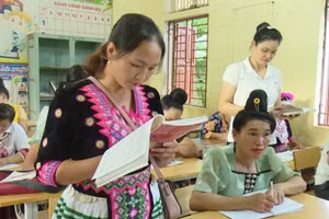 Các học viên được giáo viên hướng dẫn tập đọc tại lớp học.