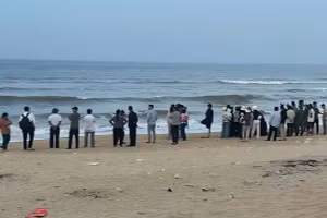 Người nhà nạn nhân và lực lượng chức năng, người dân đứng trên bờ biển Vinh Thanh tìm kiếm. (Ảnh: T.H)