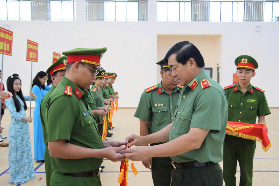 Thiếu tướng Nguyễn Văn Hận, Giám đốc Công an tỉnh An Giang, trao cờ lưu niệm cho các đơn vị.
