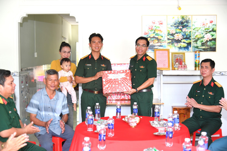 Đại diện Ban Chỉ huy Phòng thủ khu vực 5 - An Biên trao tặng quà cho gia đình Thượng úy Danh Minh Hoài. Ảnh: Phương Vũ. nha-dong-doi-0.jpg