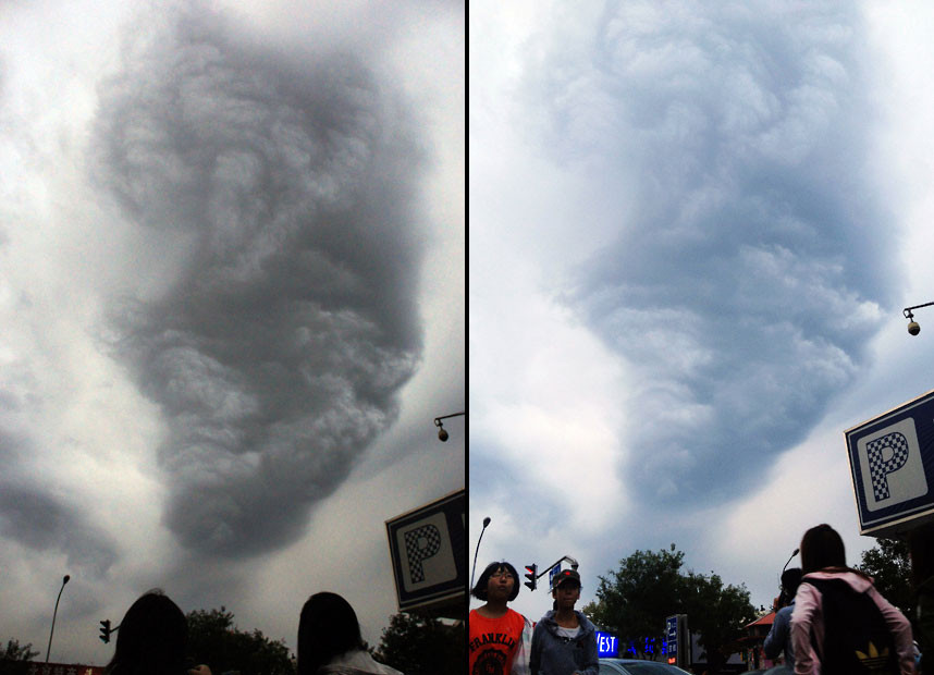 Những hình ảnh ấn tượng trong tuần ảnh 4 People look at a cloud in the shape of a tornado that was seen in the sky over Beijing for about ten minutes