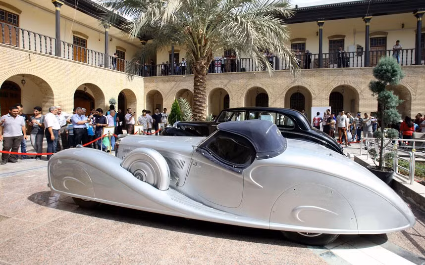 People look at a 1932 Mercedes Benz offered by Nazi Germany’s dictator Adolf Hitler to Iraq’s King Ghazi, who ruled Iraq until his death in 1939, during an exhibition in Baghdad