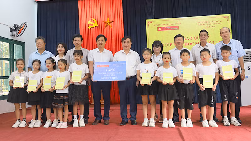 Lãnh đạo Ban Tuyên giáo Trung ương và Nhà xuất bản giáo dục Việt Nam tặng quà tại Làng trẻ em SOS. (Ảnh: Hiền Chi).