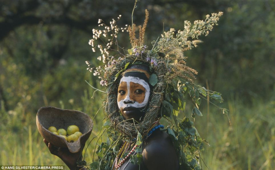 Incredible: The photographs have been published in a new book: ’Natural Fashion: Tribal Decoration from Africa’, published by Thames and Hudson Read more: http://www.dailymail.co.uk/news/article-2294456/Painted-faces-scarred-bodies-wooden-guns-extravagant-headdresses-Amazing-photographs-reveal-lost-world-Omo-tribes-Ethiopia.html#ixzz2Nmzj1a4G Follow us: @MailOnline on Twitter | DailyMail on Facebook