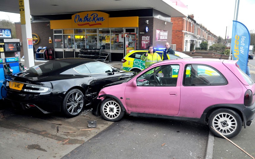 A shocked driver could only watch when his £100,000 Aston Martin DBS was written off while he filled up with petrol. The motorist had pulled up to a pump at the Esso garage in Kingshill, Wiltshire, when the driver of a pink Vauxhall Corsa lost control on the roundabout and she collided with his vehicle on the forecourt. Nobody was injured in the incident but the driver of the Aston Martin said his car was beyond repair. That will be a write-off. They won’t fix that, he said.