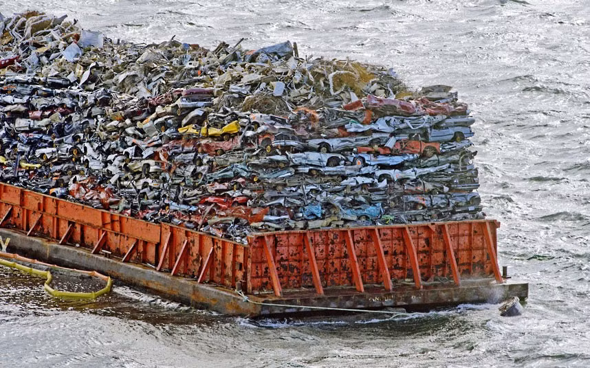 A barge laden with scrap car hulks is anchored in Commencement Bay, Tacoma, Washington, America. On Sunday it was listing and lost some of the cars into the waters of Puget Sound, but is level again.