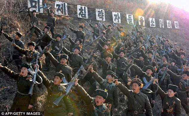 Warlike: North Korean members of the Worker-Peasant Red Guards shouting anti-U.S. slogans Read more: http://www.dailymail.co.uk/news/article-2293200/North-Korea-uses-live-artillery-drills-near-border-Kim-Jong-Un-continues-threats.html#ixzz2NWZuhaaS Follow us: @MailOnline on Twitter | DailyMail on Facebook