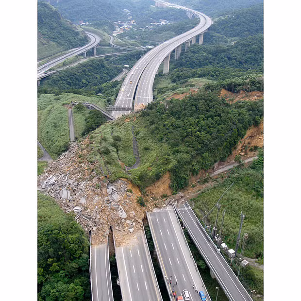 A landslide covers National Highway No. 3 close to Keelung in north Taiwan. Rescuers are searching for passengers in three cars buried when a hillside collapsed