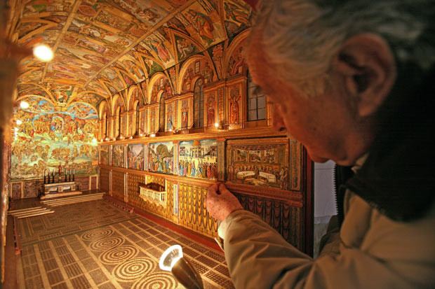 Jean Massa, of Nice, southern France points out details in his scale model of the Vatican’s Sistine Chapel, which is displayed in a church in Nice. His model is 1.45m long and 0.7m high and took him about 5,000 hours to build. 