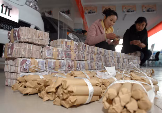Employees at a car dealership in Qingdao, Shandong Province, China, were left with the headache after a customer purchased a new 40,000 Yuan (£4,000) vehicle using a huge pile of small change. Together the payment weighed in at 100kg.
