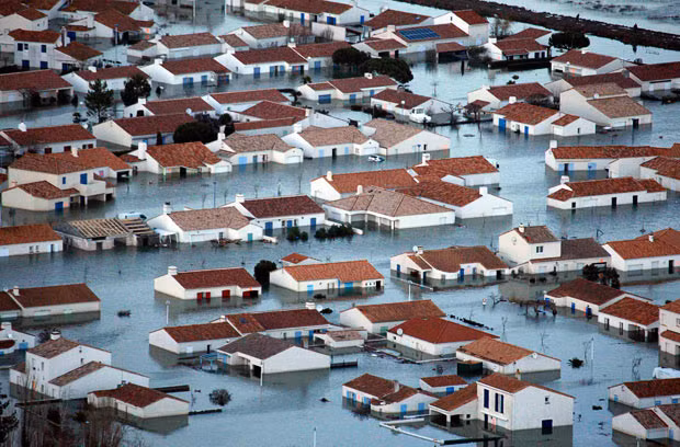 An aerial view shows flooded houses and streets in L’aiguillon sur Mer, southwestern France, following a major storm named Xynthia