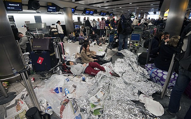 Passengers stranded at Heathrow were forced to sleep wherever they could. Many bedded down on the floors, surrounded by their luggage and piles of rubbish, while others used foil blankets to ward off the extreme cold P