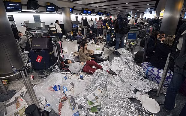 Passengers stranded at Heathrow were forced to sleep wherever they could. Many bedded down on the floors, surrounded by their luggage and piles of rubbish, while others used foil blankets to ward off the extreme cold P