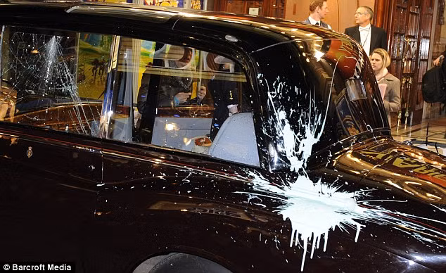 Charles and Camilla’s Car was hit by a paint bomb Read more: http://www.dailymail.co.uk/news/article-1337088/TUITION-FEES-VOTE-PROTEST-Charles-Camillas-car-attacked-thousands-students-descend-Parliament.html#ixzz17fyVSyaa