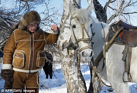 Putin looks at a horse in the Karatash area, near the town of Abakan Read more: http://www.dailymail.co.uk/news/worldnews/article-1255992/Action-man-Putin-King-wild-frontier-.html#ixzz0hRatI9Lp