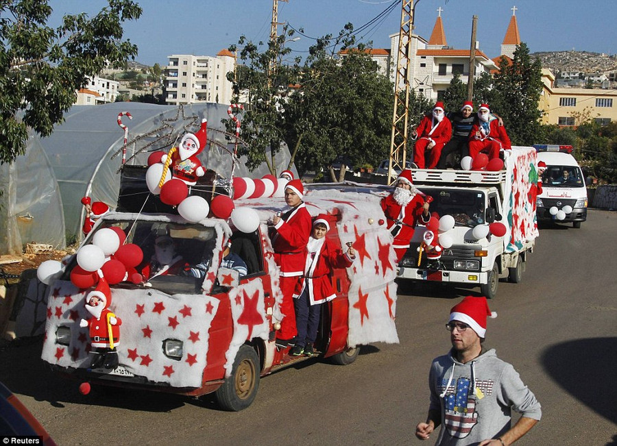 Lebanese Christians dress up as Santa and decorate their cars to celebrate the birth of Christ in a convoy in the Jiyeh village in southern Beirut Read more: http://www.dailymail.co.uk/news/article-2528947/Crowds-gather-Bethlehem-Christmas-Eve-celebrations-amid-calls-peace-Middle-East.html#ixzz2oS4cv6yz Follow us: @MailOnline on Twitter | DailyMail on Facebook