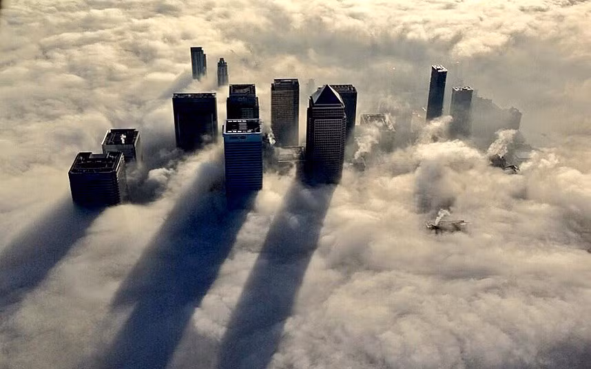 The skyscrapers of Canary Wharf loom out of the early morning fog that blanketed parts of London on the 11th December. The photo was taken from a police helicopter.