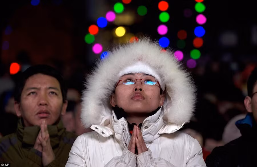 A woman prays during a Christmas Eve mass service at the official Catholic church South Cathedral in Beijing, China Read more: http://www.dailymail.co.uk/news/article-2528947/Crowds-gather-Bethlehem-Christmas-Eve-celebrations-amid-calls-peace-Middle-East.html#ixzz2oS4Uun6C Follow us: @MailOnline on Twitter | DailyMail on Facebook