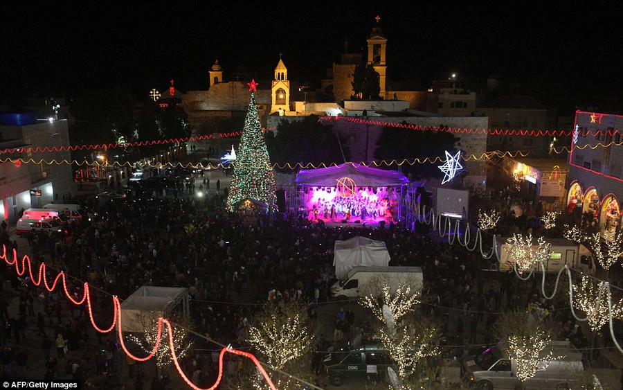 A view of Manger Square and the Church of the Nativity as people father for Christmas eve celebrations in Bethlehem Read more: http://www.dailymail.co.uk/news/article-2528947/Crowds-gather-Bethlehem-Christmas-Eve-celebrations-amid-calls-peace-Middle-East.html#ixzz2oS3IrmkS Follow us: @MailOnline on Twitter | DailyMail on Facebook