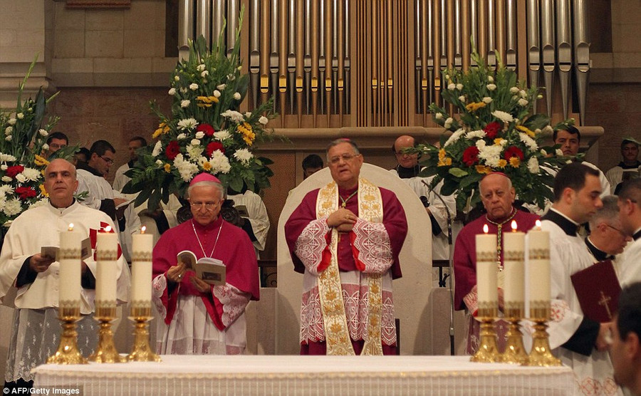 The Latin Patriarch of Jerusalem Fuad Twal leads the service at the Church of the Nativity as thousands of Palestinians and tourists flocked into the West Bank city of Bethlehem to mark Christmas in the 
