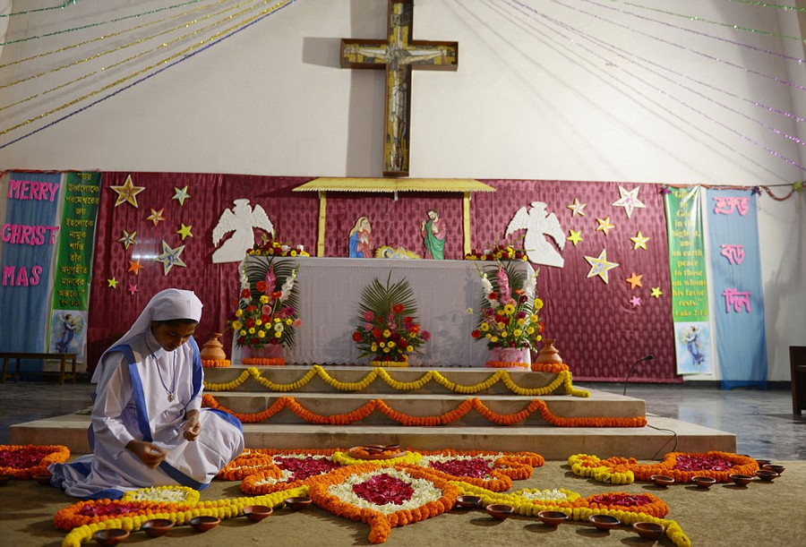 A nurse in Dhaka, Bangladesh, decorates the St Marys Cathedral on Christmas Eve where 90 per cent of the population are Muslim Read more: http://www.dailymail.co.uk/news/article-2528947/Crowds-gather-Bethlehem-Christmas-Eve-celebrations-amid-calls-peace-Middle-East.html#ixzz2oS3r2UJ3 Follow us: @MailOnline on Twitter | DailyMail on Facebook