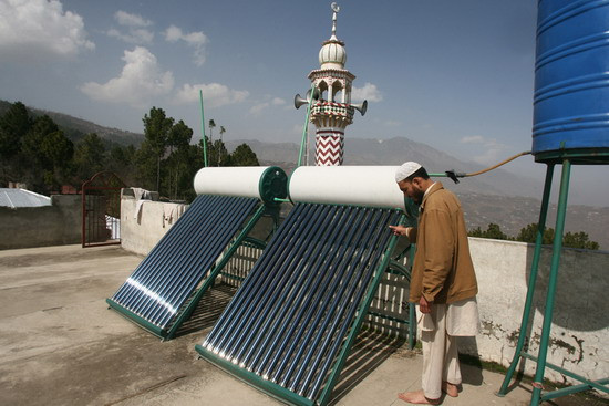 Kashif shows solar geysers on the roof of his seminary in Murree, Pakistan on March 6, 2012. Pakistanis are increasingly realizing that year-round sun is a cheap answer to an enormous energy crisis. Pakistan needs to produce 16,000 megawatts of electricity for daily demand, but falls short by providing only 13,000 megawatts.
