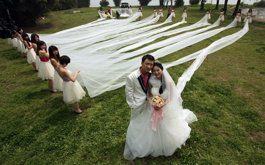 Newlyweds pose for photos at Wuhan Botanical Garden in China. The bride wore a dress with a 520-metre-long train.