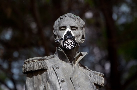 A gas mask covers the face of independence hero Leonardo Bravo’s statue in Mexico City on February 28, 2012. Activists are protesting pollution by placing gas masks on statues of Mexican heroes