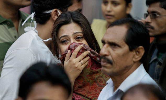 Rescue workers had to break windows to get to residents trapped on the upper floors, but they were too late to save this woman Read more: http://www.dailymail.co.uk/news/article-2071981/60-dead-blaze-tears-Indian-nursing-home.html#ixzz1g3089PfS