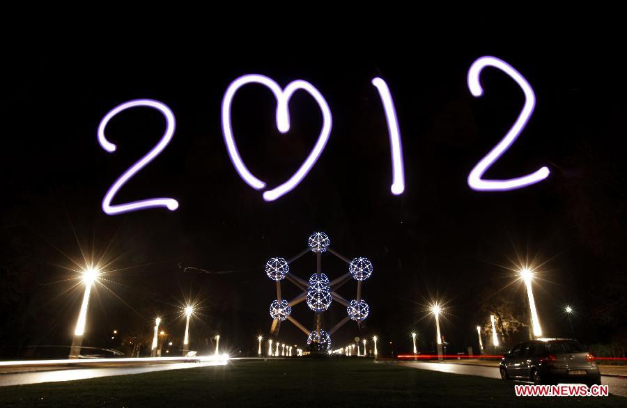 The light painting photo taken on Dec. 29, 2011 in front of the Atomium in Brussels, Belgium, shows the sign of 