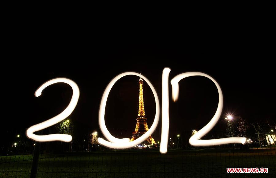 The light painting photo taken on Dec. 29, 2011 in front of the Eiffel Tower in Paris, France, shows the sign of 