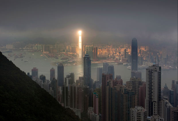 A bright beam of sunlight illuminates one of the tallest buildings in the world - the 1,588ft tall, 108-floor International Commerce Centre in Hong Kong - while leaving the rest of the cityscape in cloudy darkness. The moment was captured by keen Russian photographer Pavel Kiselev.