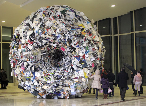 People look at a sculpture by Alicia Martin, made of 3,000 books, at City of Culture of Santiago de Compostela, in Galicia, Spain
