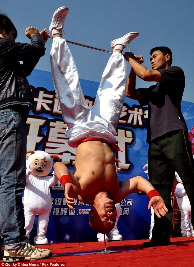 Impressive: 47-year-old Li can hold the pose with his legs up against a bar for more than 10 seconds - far longer than most people would be able to do a simple headstand Read more: http://www.dailymail.co.uk/news/article-2070586/Stuntman-Li-Xin-balances-nail-head.html#ixzz1fqJdCh6e