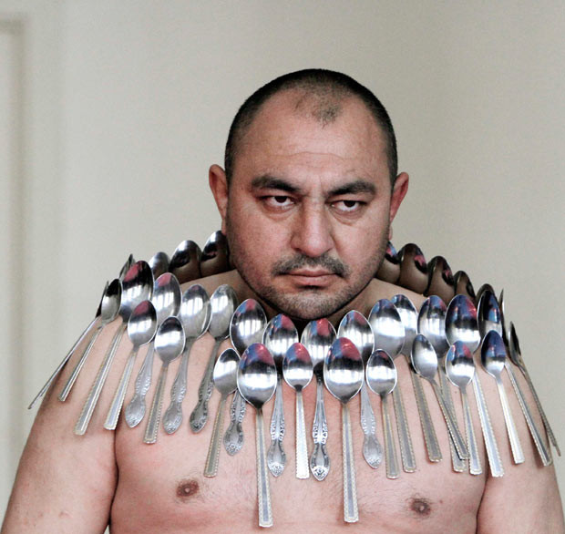 Etibar Elchiyev poses with 50 metal spoons magnetized to his body during an attempt to break the Guinness World Record for 