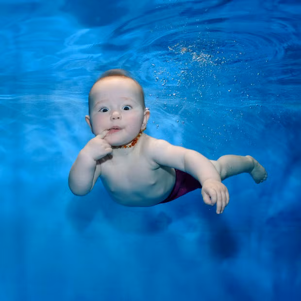 A baby swims underwater at London Baby Swim Centre in Osterley, West London. The specialist centre caters for babies from just six weeks old.