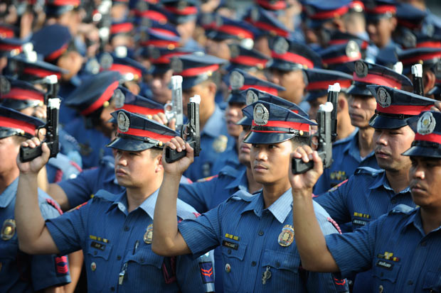 Members of the Philippine national police force display their taped-up gun barrels in Manila, intended to prevent any the gunfire that has plagued the country every New Year. The taping will ensure that any policeman who fires his gun into the air on New Year