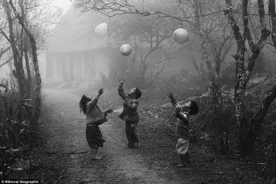 Vo Anh Kiet: H’Mong minority children were playing with their balloons on the foggy day in Moc Chau - Ha Giang province Viet Nam in January 2012 Read more: http://www.dailymail.co.uk/news/article-2189479/National-Geographic-reveal-winners-2012-Photo-Contest.html#ixzz23mBYRuES