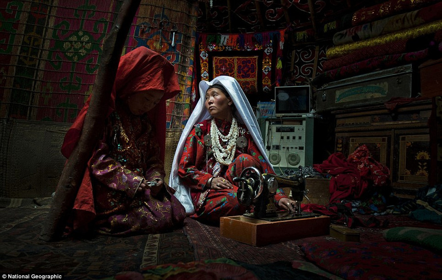 Winner Cedric Houin: This image was shot in the Kyrgyz lands of the Wakhan Corridor. The intimacy of this everyday life moment, shot inside of a family yurt, is in total contrast with the harsh environment these nomadic tribes live in Read more: http://www.dailymail.co.uk/news/article-2189479/National-Geographic-reveal-winners-2012-Photo-Contest.html#ixzz23mAKLtUb